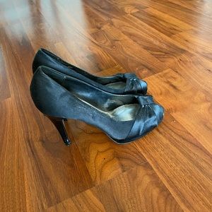 Black heels with bow tie detail. White House black market.